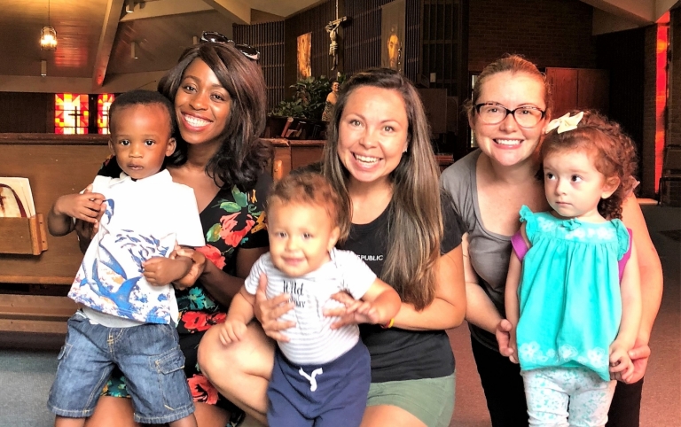 Three school moms with their infants in the church