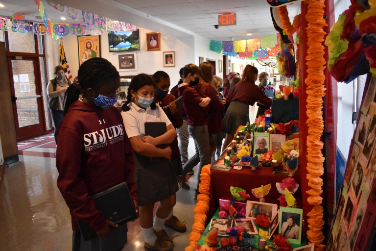 Students learn about el dia de los muertos while visiting the school's ofrenda